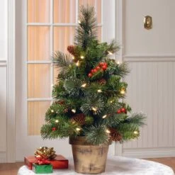 2ft. Pre-Lit Crestwood Spruce Small Tree With Silver Bristle, Cones, Red Berries & Glitter In A Plastic Bronze Pot, Clear Lights 9 2ft. Pre-Lit Crestwood Spruce Small Tree With Silver Bristle, Cones, Red Berries & Glitter In A Plastic Bronze Pot, Clear Lights -Northlight Shop D206316S 2