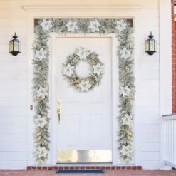 Glitzhome® 9ft. Pre-Lit Snow Flocked Greenery Pine Poinsettia Christmas Garland 12 Glitzhome® 9ft. Pre-Lit Snow Flocked Greenery Pine Poinsettia Christmas Garland -Northlight Shop D652256S 2