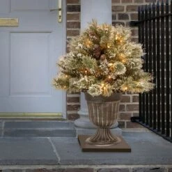 24" Glittery Bristle® Pine Porch Bush In Dark Bronze Plastic Urn With White Tipped Cones -Northlight Shop D739666S 2