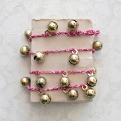Hello Honey® 6ft. Gold Finish Metal Bells On Braided Red & White Cord Garland -Northlight Shop D823490S 2